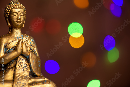 a golden buddha statue against a colored background