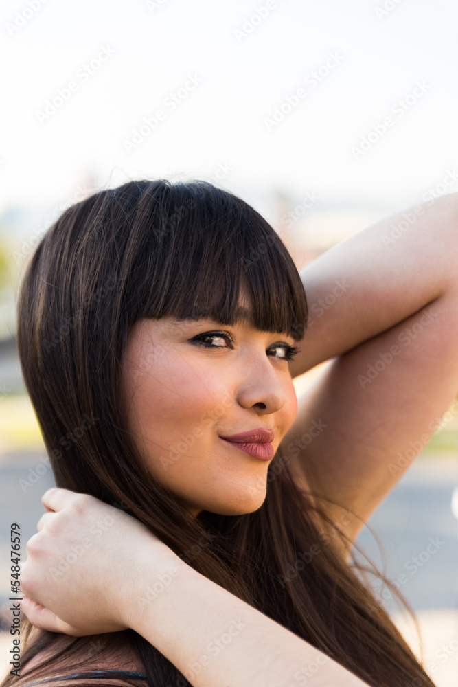 Asian european young woman in the streets of Barcelona, Spain. She is brunette, with a fringe haircut and wears summer clothes Asian european young woman in the streets of Barcelona, Spain. She is brunette, with a fringe haircut and wears summer clothes