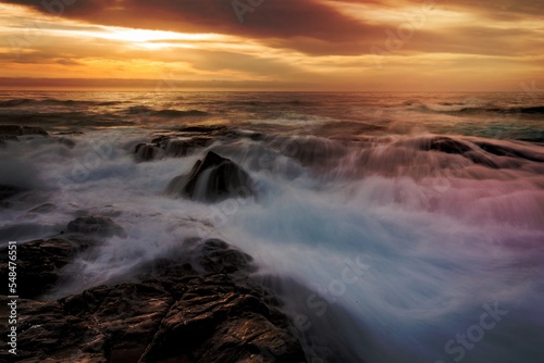 Mystical light over the ocean with rocky ocean cascades