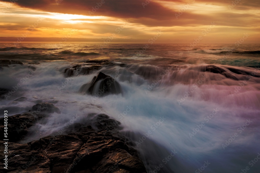 Mystical light over the ocean with rocky ocean cascades