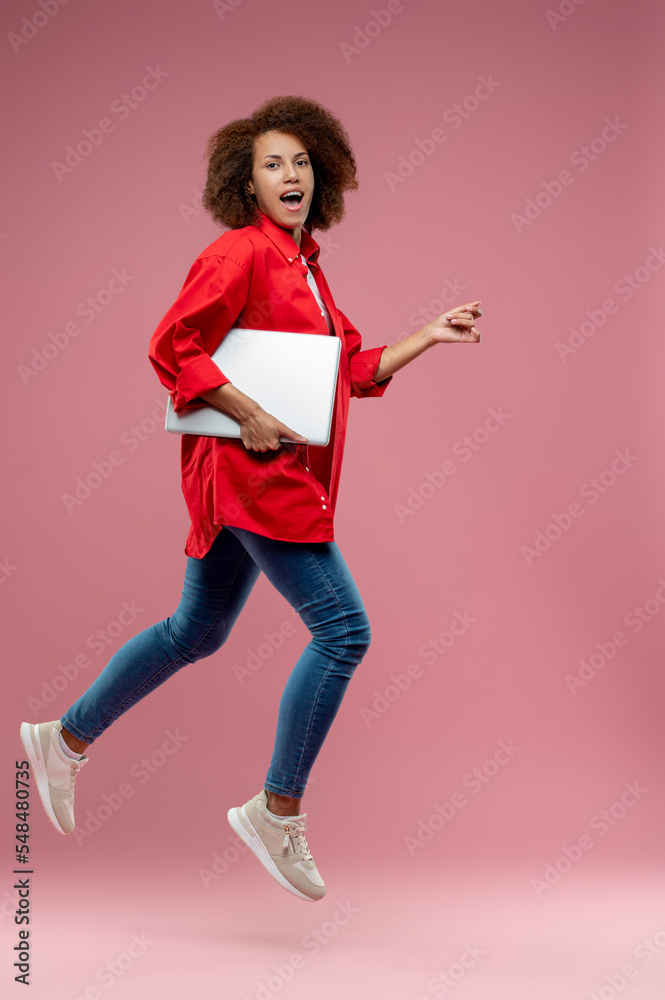 Businesswoman with a laptop looking active and excited