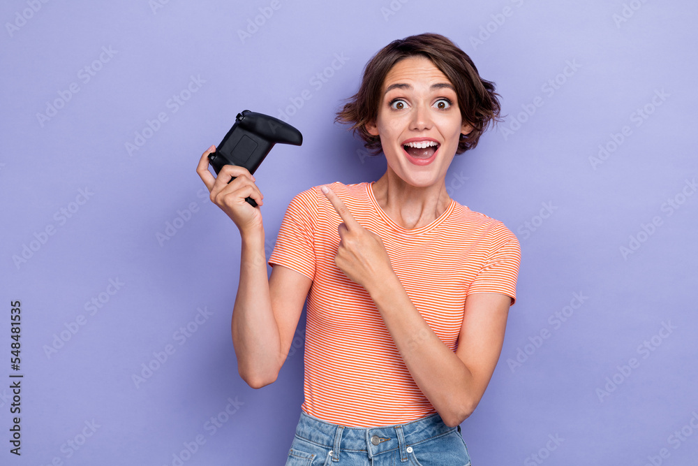 Photo of overjoyed positive lady arm direct index playstation offer buy use pastime free time isolated on purple color background Photo of overjoyed positive lady arm direct index playstation offer buy use pastime free time isolated on purple color background