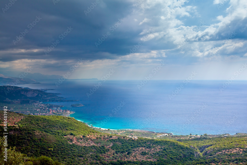 Beautiful panoramic landscape with dark clouds ready to bring rain comes over Kardamyli town, in eastern Messinia region, in Peloponnese, Greece, Europe. 