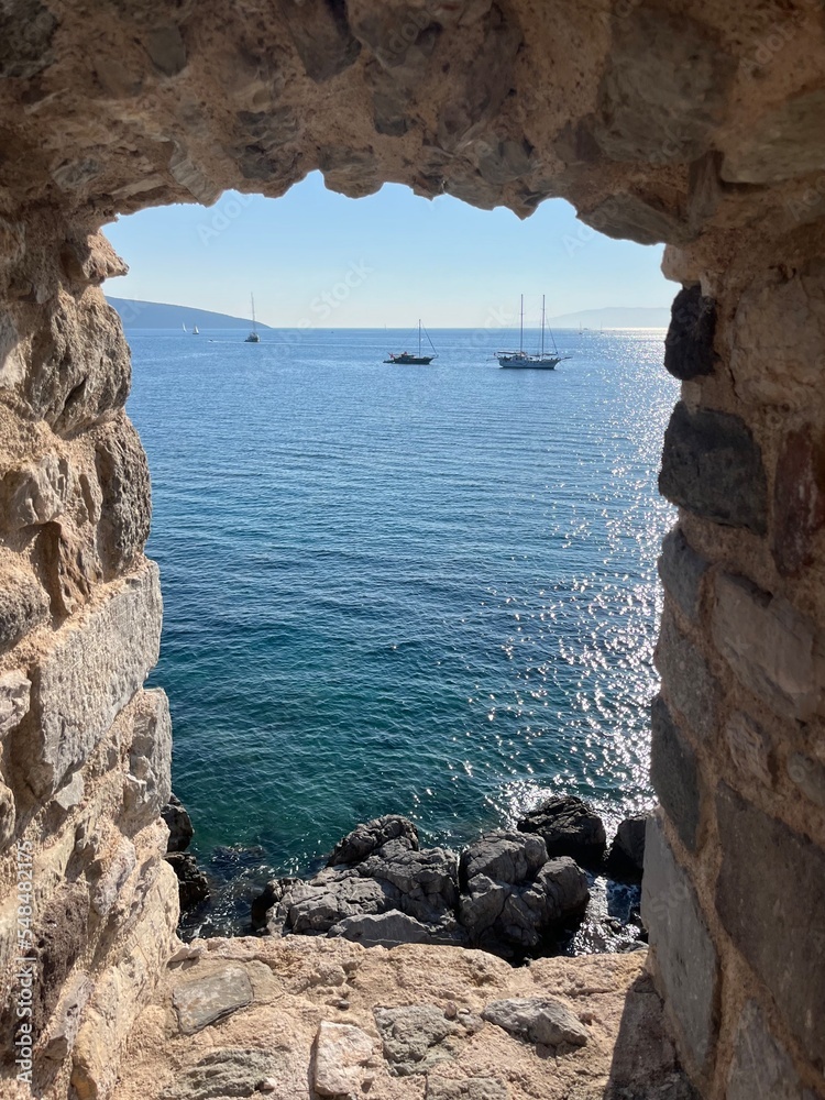 Fortress at the Aegean sea, blue sea, stone walls
