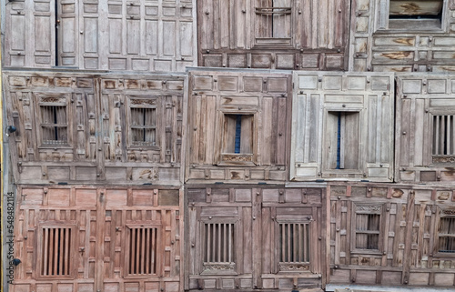Old wooden windows hidden in traditional texture and background.