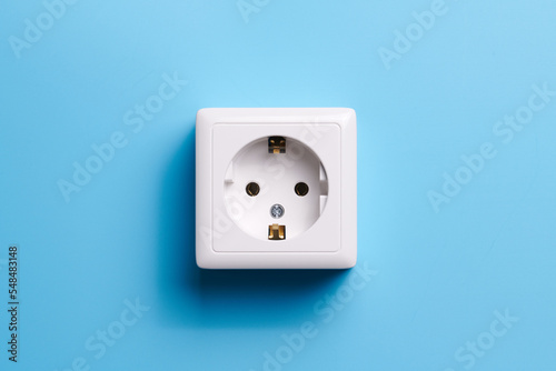 White socket isolated on a blue background. Electric lighting concept