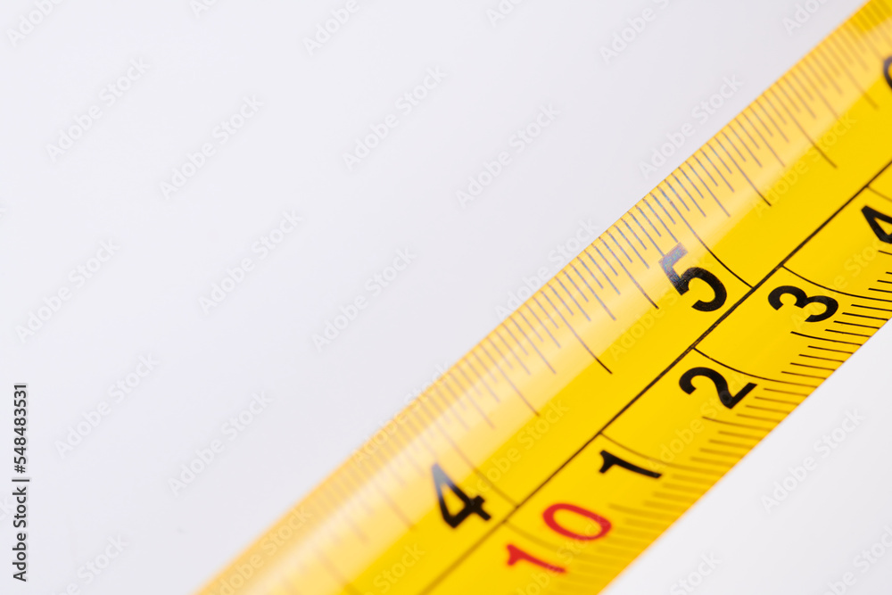 Yellow carpenter measuring tape with centimeters isolated on white background. Construction tool. Yellow carpenter measuring tape with centimeters isolated on white background. Construction tool.