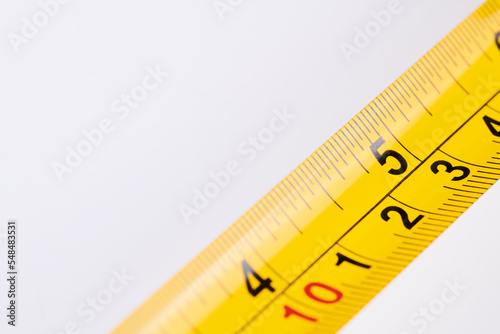 Yellow carpenter measuring tape with centimeters isolated on white background. Construction tool.