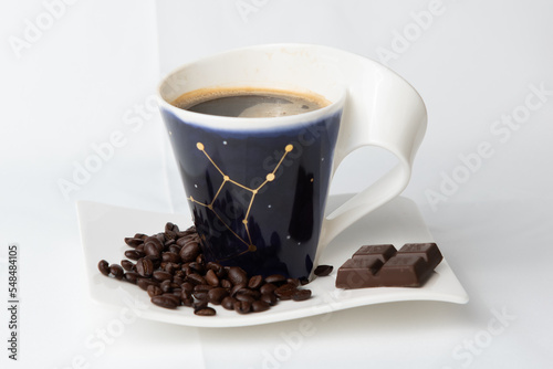 cup of coffee with beans.coffee cup and beans on a plate.coffee and beans on a plate with chocolate
