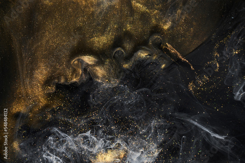 Golden sparkling abstract background  luxury black smoke  acrylic paint underwater explosion  cosmic swirling ink