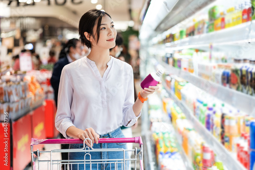 Asian woman going to the supermarket to buy supplies photo