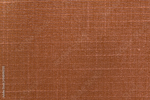 Close-up natural linen fabric of brown color. Texture of natural material. Textile as background