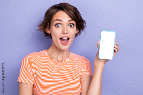 Close up photo of astonished lady hand hold show device gadget impressed low price shop empty space isolated on purple color background