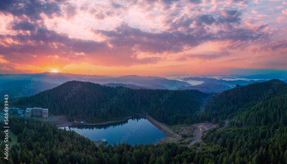 Lake bay with highway on shore and high Rhodope Mountains surrounded. Panorama, top view