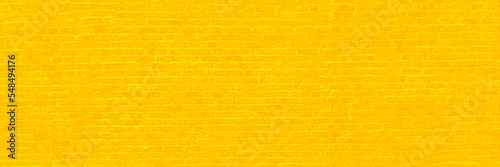 Brick wall yellow for texture background. Photograph of a brick yellow wall