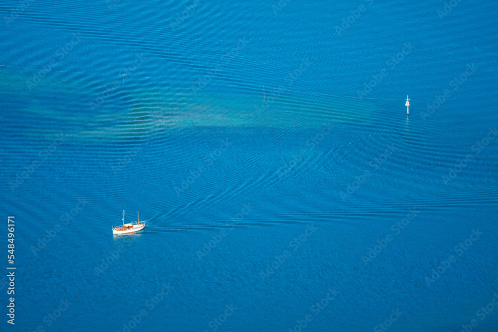Aerial view of a paraglider flying above the Lake Wakatipu, Queenstown, South Island, New Zealand. Aerial view of a paraglider flying above the Lake Wakatipu, Queenstown, South Island, New Zealand.