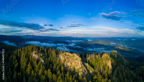 Peak of mountain range with forest in valley Rhodope mountains under sunset. Panorama, top view