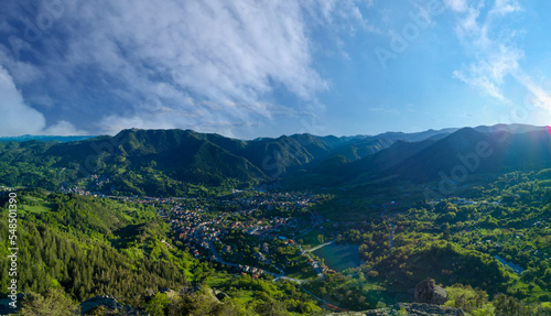 Bulgarian town Smolyan with lake, vegetation and clouds. Rhodope Mountains. Panorama, top view