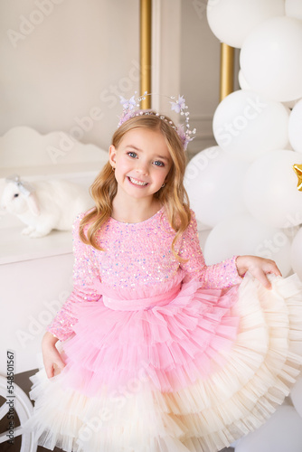 Charming beautiful girl, 6-8 years old,birthday party for a baby girl, beautiful dress, rhinestones,jewelry, soft pink, accessories for ladies, children's party, white balloons, photo zone