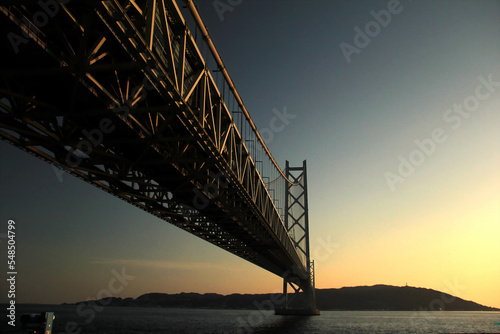 Akashi Kaikyo Bridge or Kobe Bridge with beautiful sunset, mountain and ocean view at Japan.