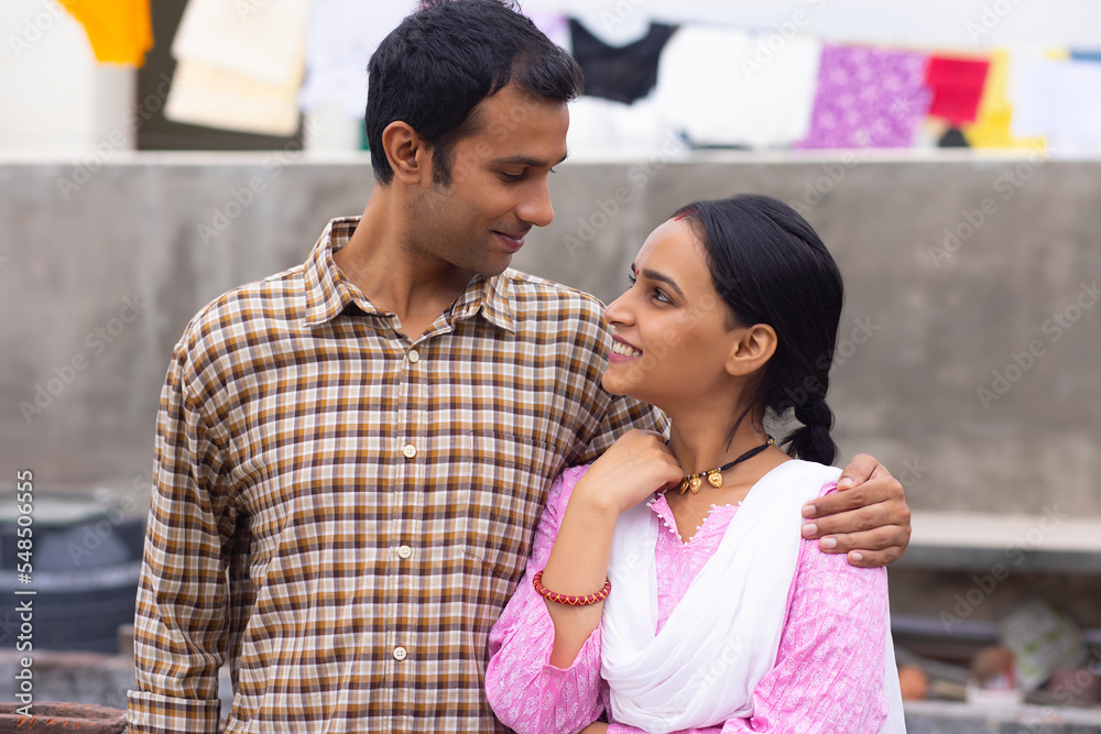 Portrait of happy young couple standing in backyard Portrait of happy young couple standing in backyard
