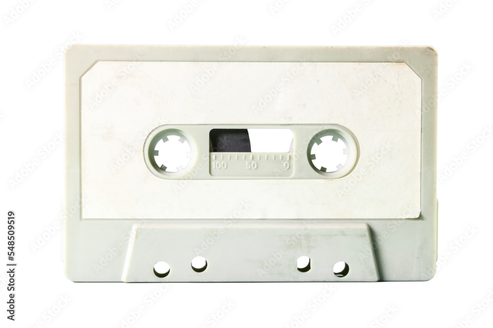 Isolated old vintage cassette tape from the 1980s (obsolete music technology). White label, light gray plastic body.
