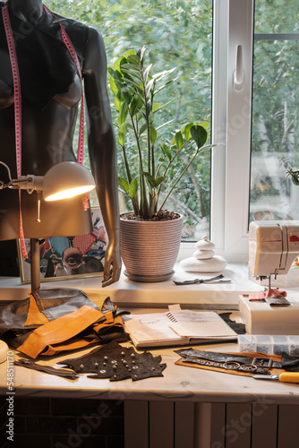 Workspace of the stylist of leather things, designer of fashionable belts and bags. Making accessories by handmade. The part of work room interior