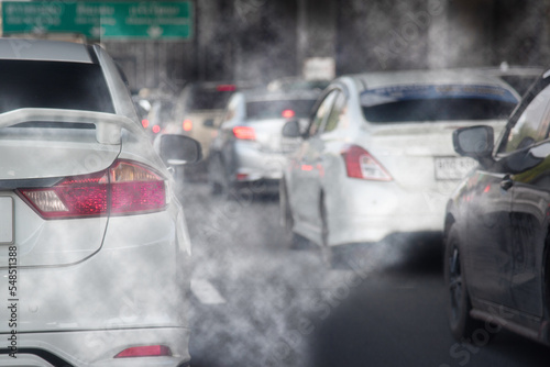 Smoke pollution from car exhaust pipes, traffic jams on the roads at rush hour.