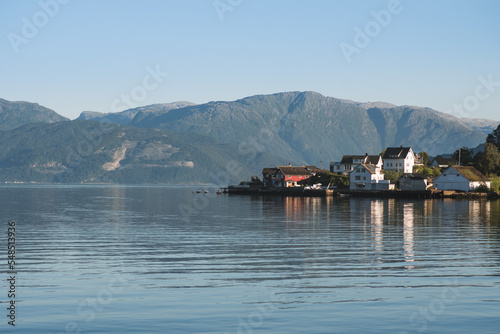 Amazing typically view to the norway village with fjord and mountain. Location: Hardangerfjordvegen, Oystese, Norway. Travel landscape. 