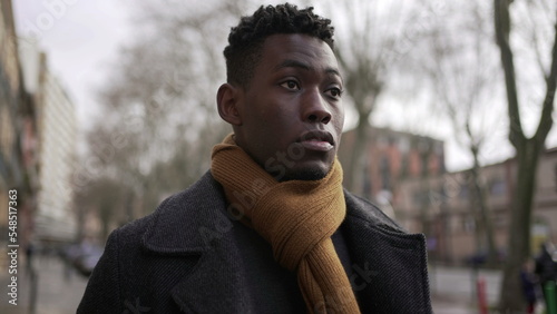 Young elegant black African man walking outside in city sidewalk3