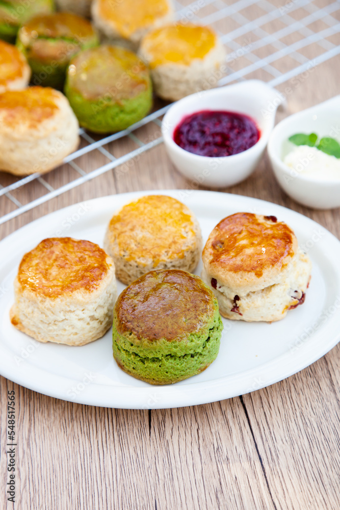 Four flavours of homemade scone with raspberry jam and clotted cream (butter, cranberry, matcha and Earl Grey) Four flavours of homemade scone with raspberry jam and clotted cream (butter, cranberry, matcha and Earl Grey)
