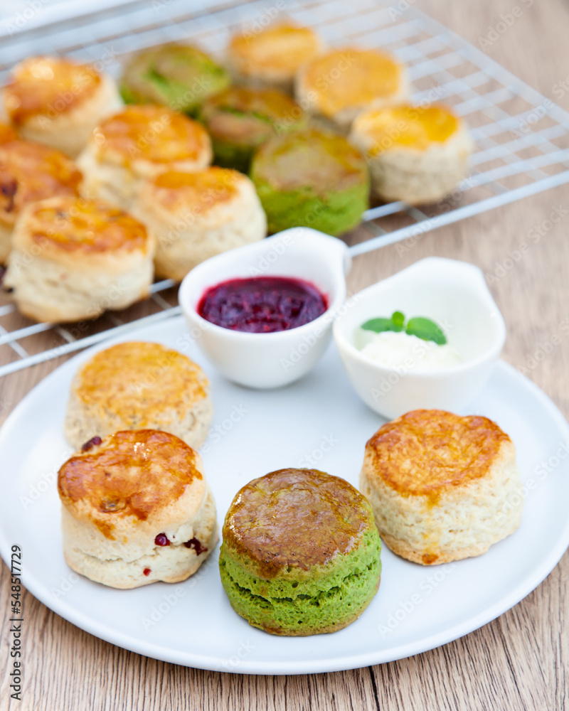 Four flavours of homemade scone with raspberry jam and clotted cream (butter, cranberry, matcha and Earl Grey) Four flavours of homemade scone with raspberry jam and clotted cream (butter, cranberry, matcha and Earl Grey)