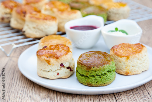 Four flavours of homemade scone with raspberry jam and clotted cream (butter, cranberry, matcha and Earl Grey)