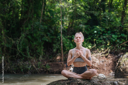 Girl practice yoga meditation outdoor in park