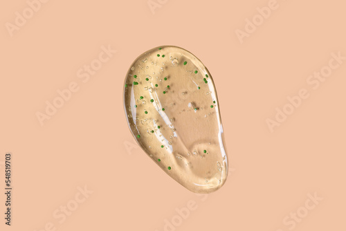 Liquid Aloe vera gel or serum on beige background
