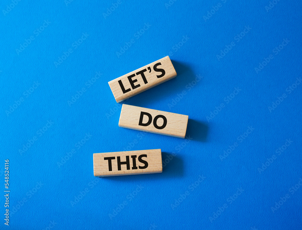 Let's do this symbol. Concept word Let's do this on wooden blocks. Beautiful blue background. Business and Let's do this concept. Copy space Let's do this symbol. Concept word Let's do this on wooden blocks. Beautiful blue background. Business and Let's do this concept. Copy space