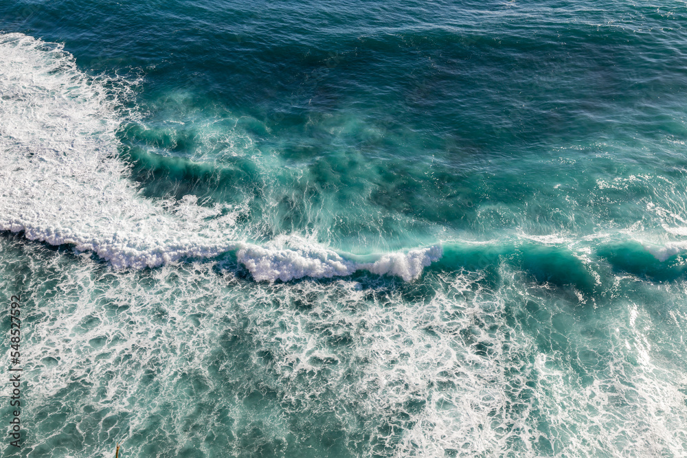 Aerial view of scenic ocean waves in Uluwatu, Bali