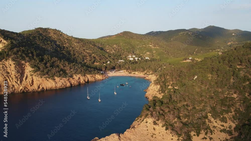 Aerial View Of Cala Benirras Beach Lit By Sunset Light In Ibiza. Dolly Forward, Establishing Shot Aerial View Of Cala Benirras Beach Lit By Sunset Light In Ibiza. Dolly Forward, Establishing Shot