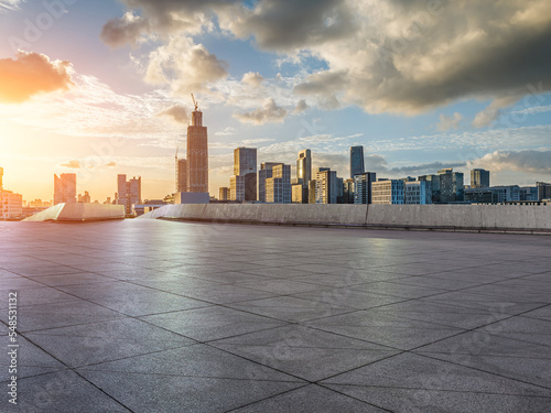 Empty square floors and modern city skyline with buildings at sunset in Ningbo, Zhejiang Province, China.