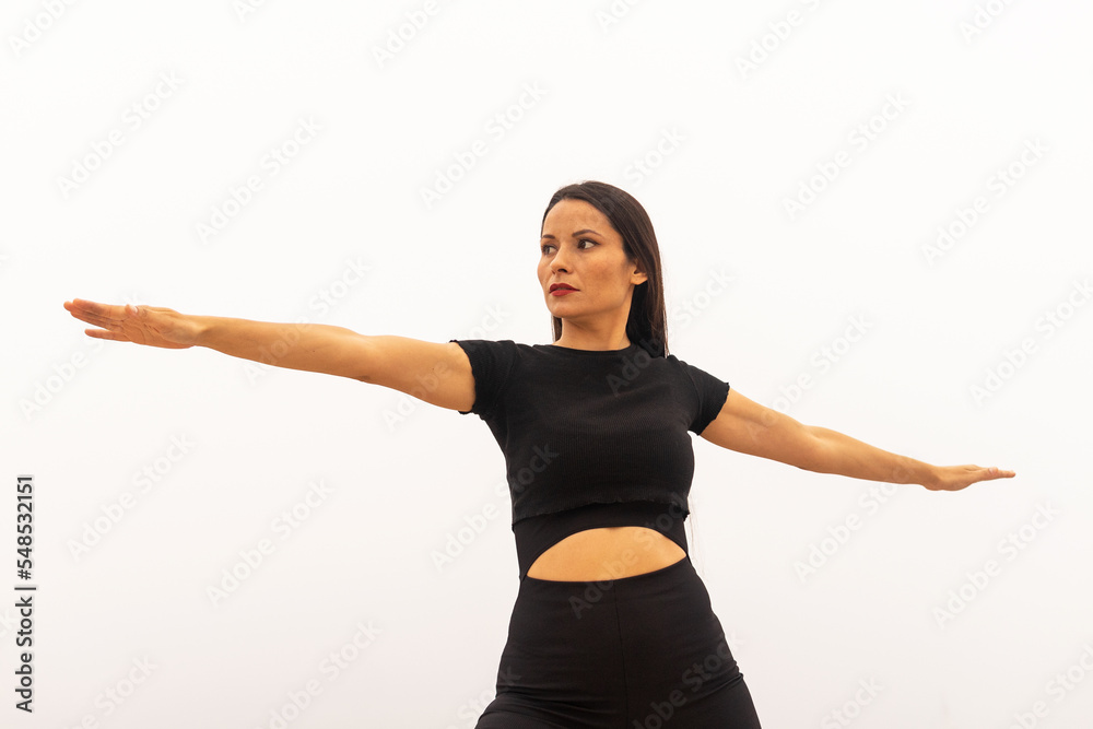 Slim female athlete doing Warrior II yoga pose Slim female athlete doing Warrior II yoga pose