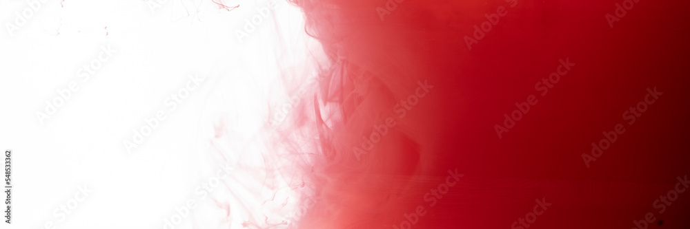 Red color flowing in smoke forms, smooth abstract moving by acrylic paint