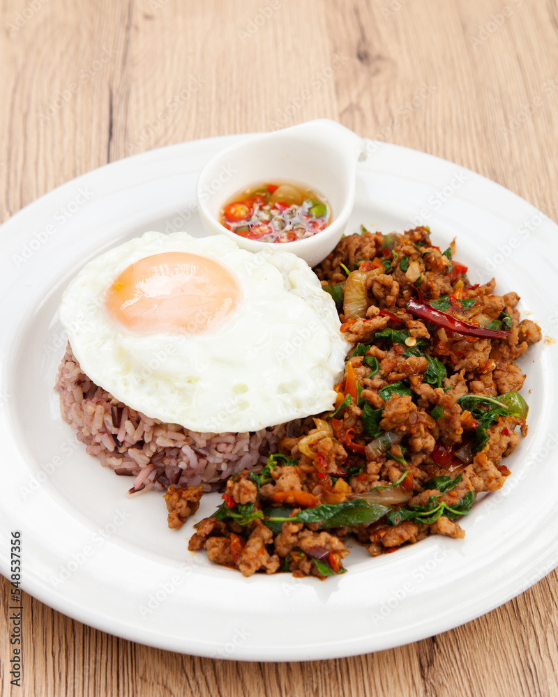 Rice with stir fried minced pork and basil topped with fried egg, Thai food called Pad Ka Prao Moo Rice with stir fried minced pork and basil topped with fried egg, Thai food called Pad Ka Prao Moo