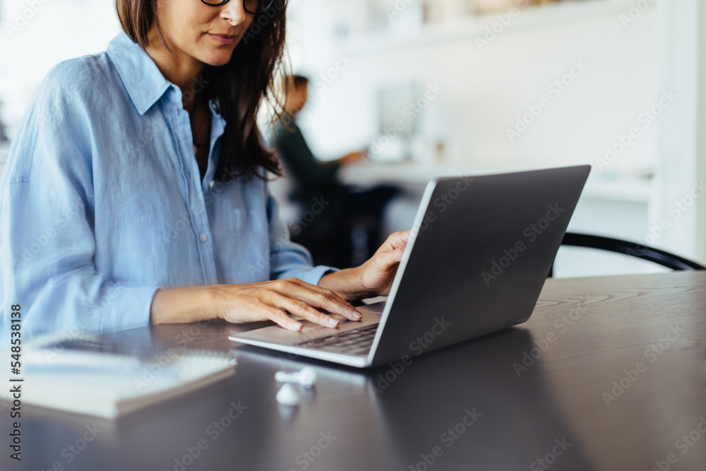 Web designer working on a laptop in an office
