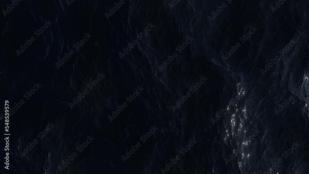Aerial view of the dark ocean. Ripples and waves on deep water surface.  Turbulent sea reflects the bright moonlight. Soft and relaxing movement. Night top view. Liquid background.