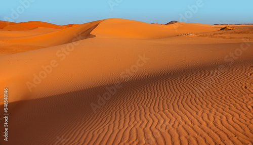 Beautiful sand dunes in the Sahara desert with amazing sunset sky - Sahara, Morocco