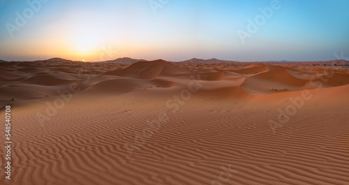 Beautiful sand dunes in the Sahara desert with amazing sunset sky - Sahara, Morocco