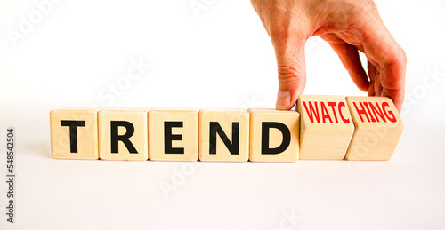 Trend or trendwatching symbol. Concept words Trend and trendwatching on wooden cubes. Businessman hand. Beautiful white table white background. Business trend or trendwatching concept. Copy space. photo