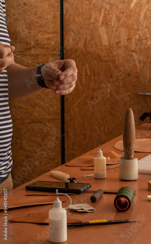 master tanner works with leather on an order