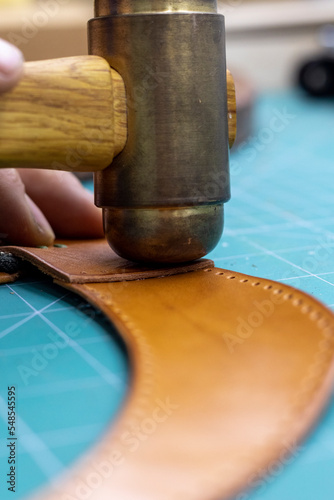 master tanner works with leather on an order