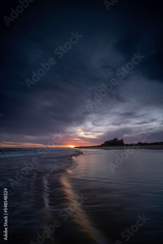 Bamburgh castle viewed at sunrise, located on the northumberland coastline.